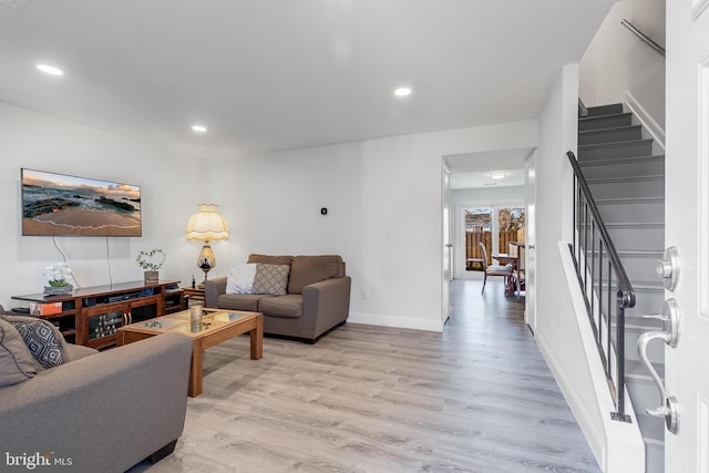 living room featuring light wood-style floors, recessed lighting, stairway, and baseboards