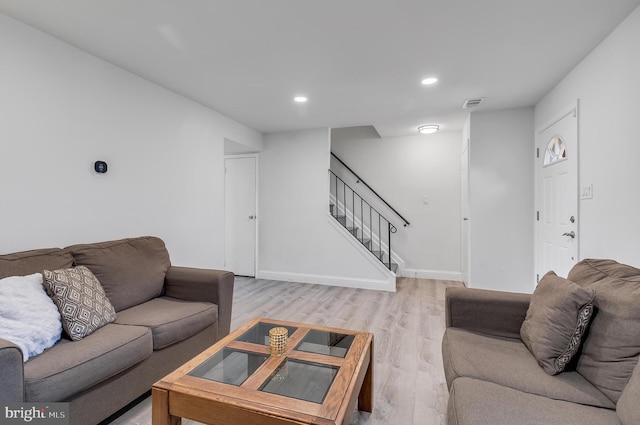 living room with light wood finished floors, recessed lighting, visible vents, stairway, and baseboards