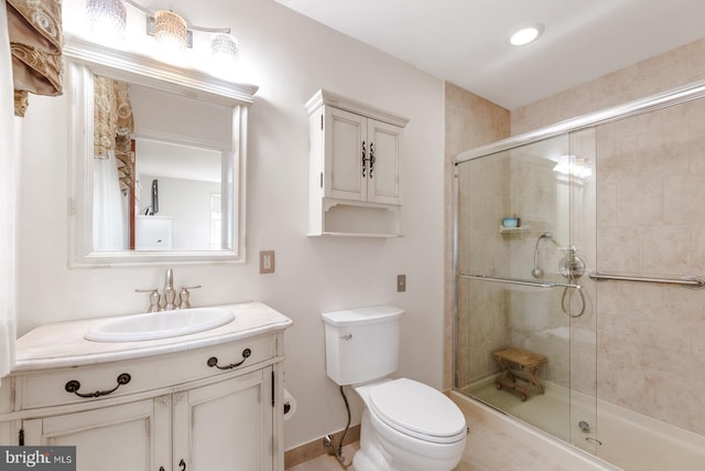 full bath featuring a stall shower, vanity, and toilet