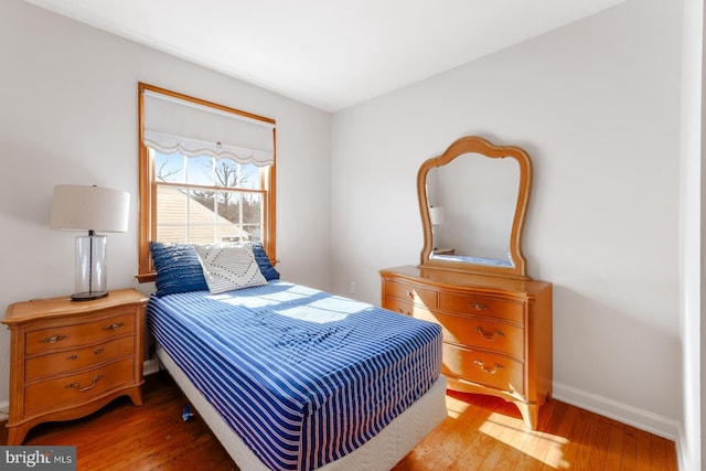 bedroom featuring light wood-type flooring and baseboards