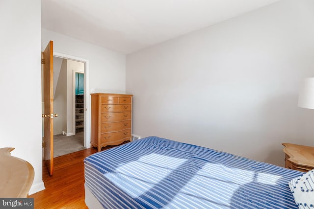 bedroom featuring light wood-type flooring and baseboards