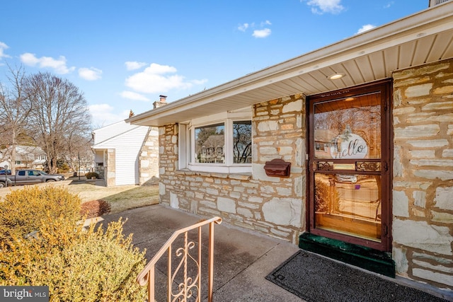 view of exterior entry featuring stone siding