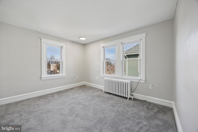 carpeted spare room with plenty of natural light, radiator heating unit, and baseboards