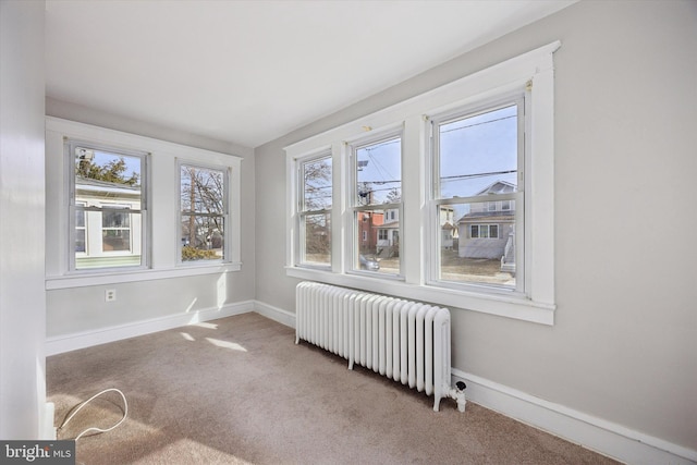 unfurnished sunroom featuring radiator heating unit