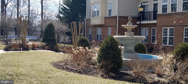 exterior space featuring fence and brick siding