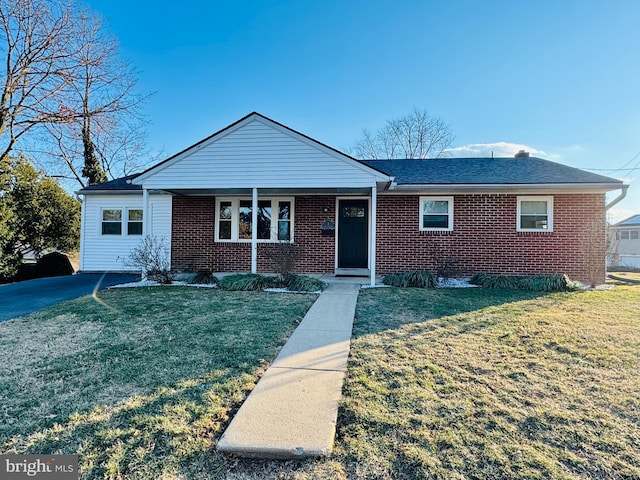 ranch-style home with brick siding and a front lawn