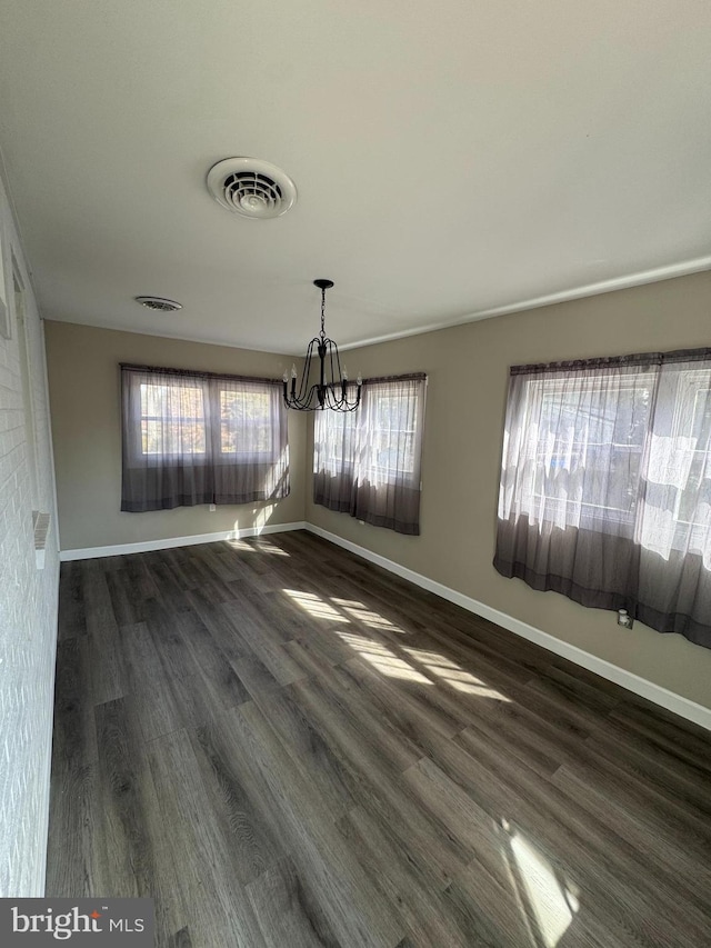 unfurnished dining area with baseboards, visible vents, and dark wood-type flooring