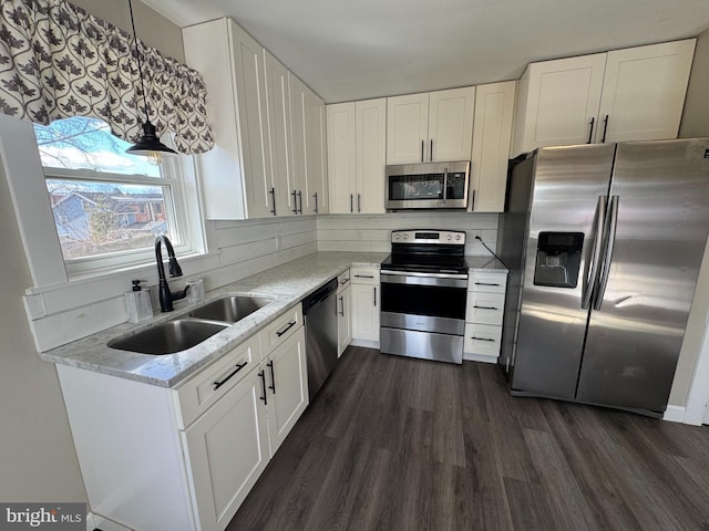 kitchen featuring dark wood-style floors, white cabinetry, appliances with stainless steel finishes, and a sink