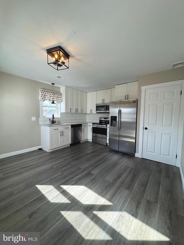 kitchen with stainless steel appliances, a sink, visible vents, white cabinets, and light countertops