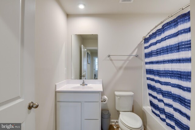 bathroom with toilet, visible vents, shower / tub combo with curtain, and vanity