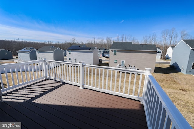 deck with a residential view and an outdoor structure