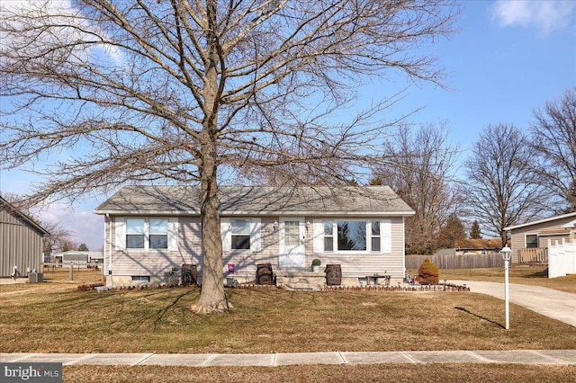 view of front of property with fence, a front lawn, and cooling unit