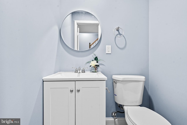 bathroom featuring toilet and vanity