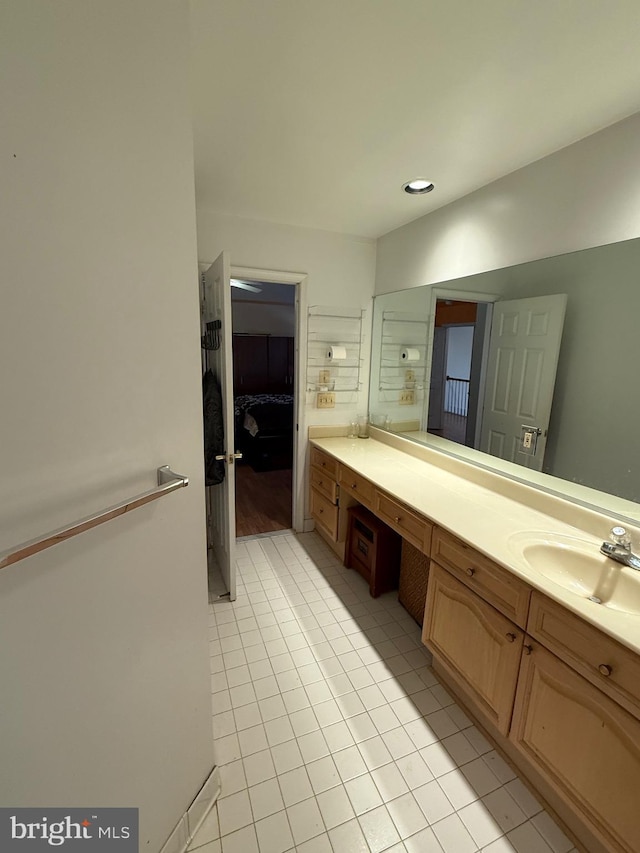 bathroom with tile patterned floors, connected bathroom, and vanity