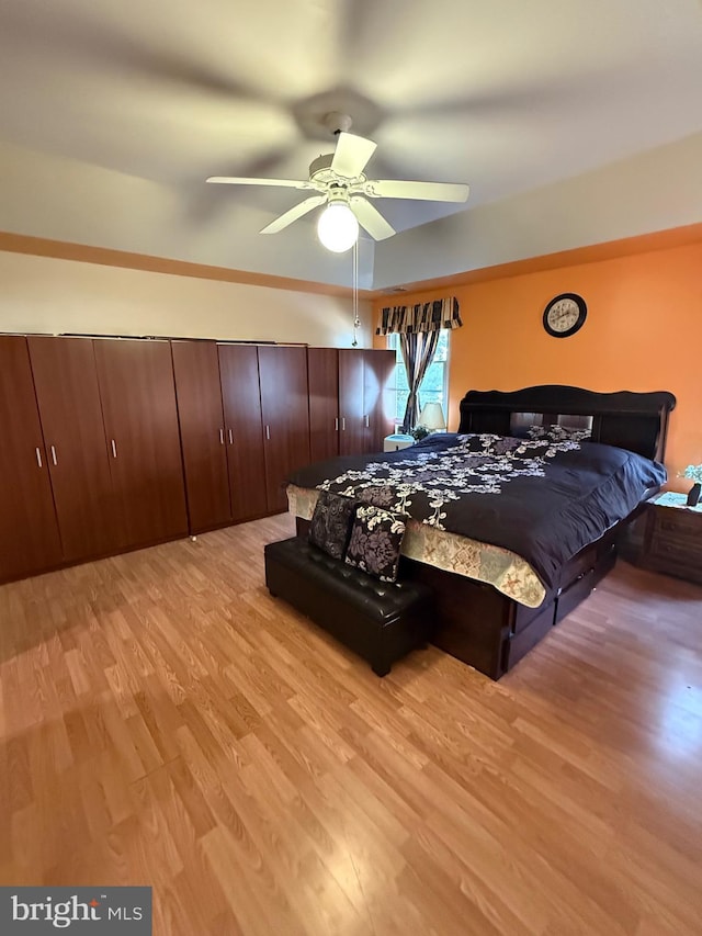 bedroom featuring light wood-type flooring and a ceiling fan