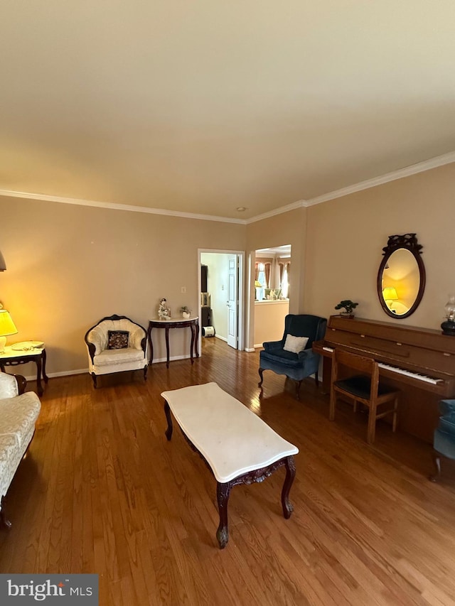 living room with crown molding and wood finished floors