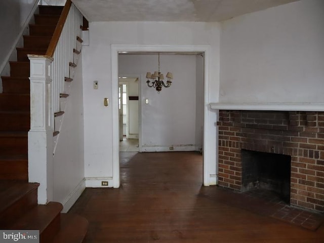 interior space featuring an inviting chandelier, stairs, baseboards, and wood finished floors