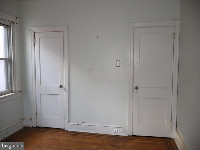 spare room featuring wood finished floors