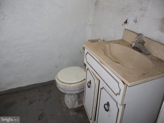 bathroom featuring toilet and vanity