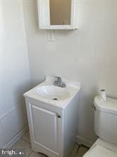 bathroom featuring toilet and vanity