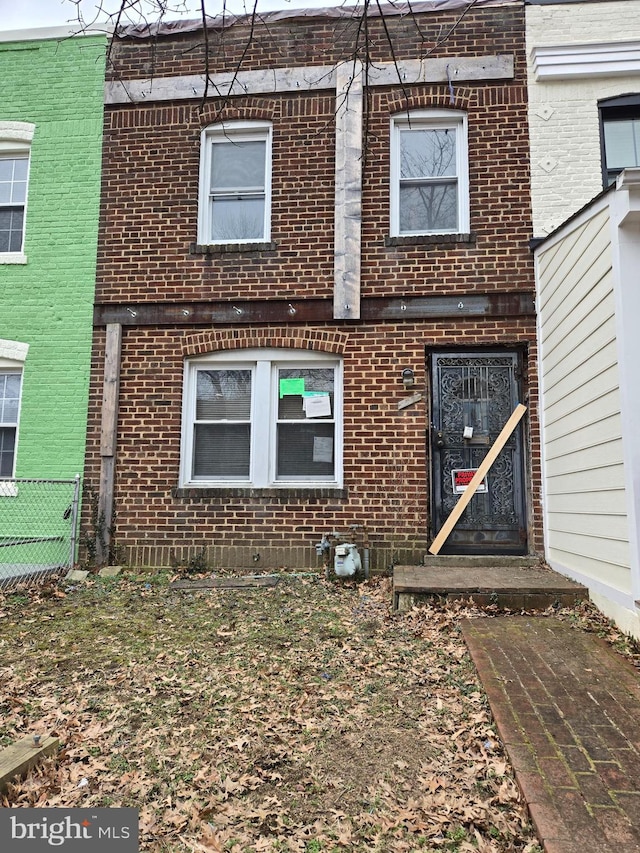 exterior space with brick siding and fence