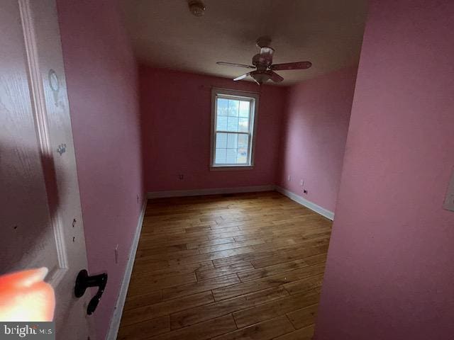 unfurnished bedroom featuring hardwood / wood-style floors and baseboards