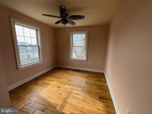 spare room with light wood-style flooring, baseboards, and ceiling fan