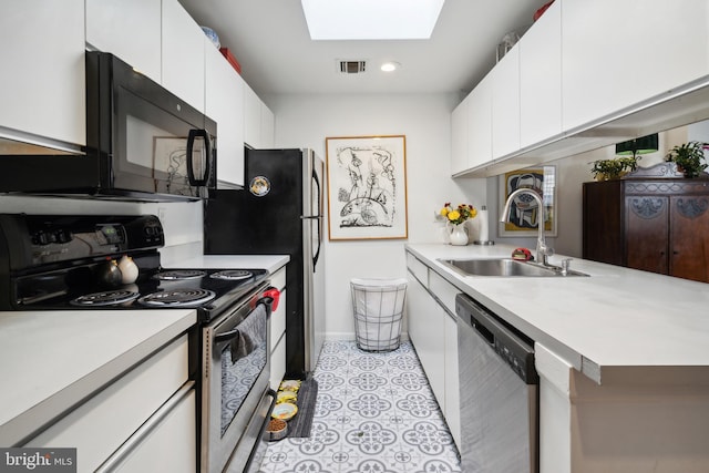 kitchen with a skylight, visible vents, electric stove, stainless steel dishwasher, and a sink