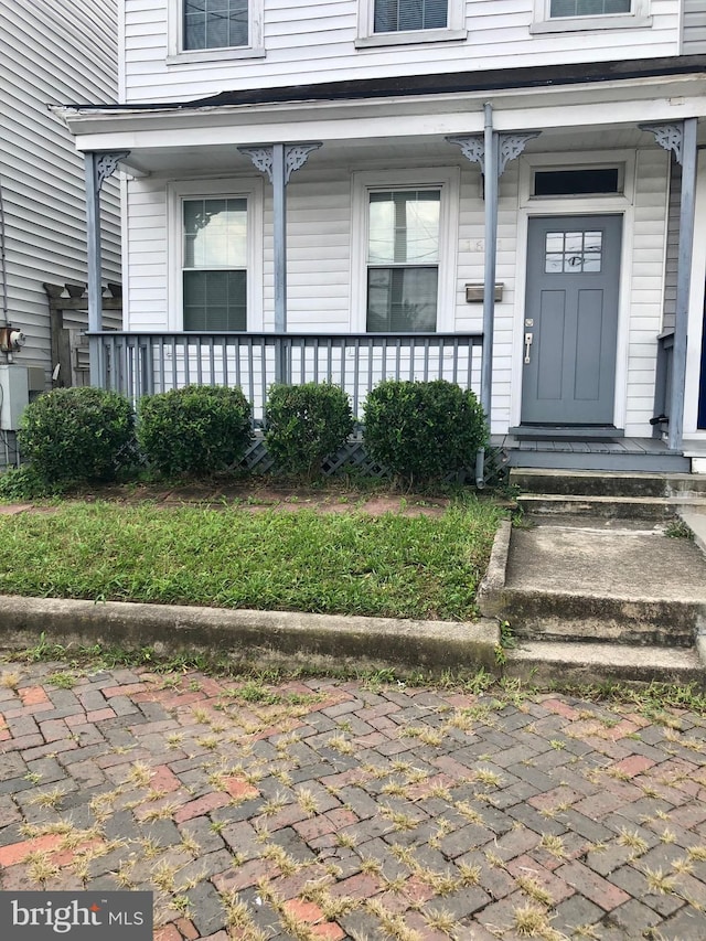 property entrance featuring covered porch