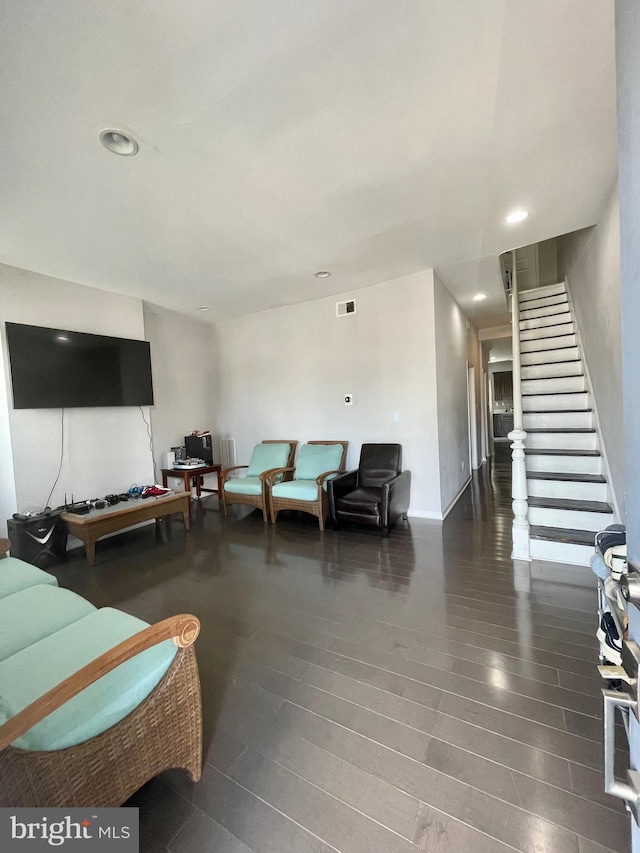 living area with stairs, wood finished floors, visible vents, and recessed lighting