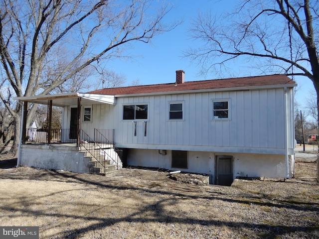 view of front of home with a shingled roof and a chimney