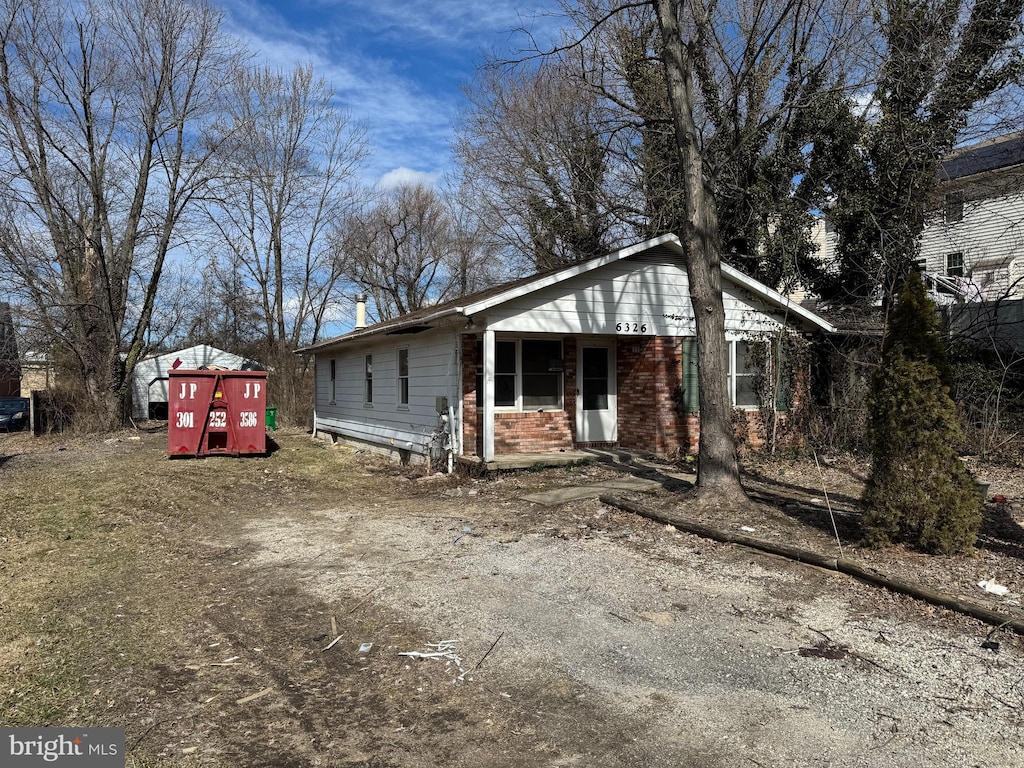 exterior space featuring brick siding and driveway