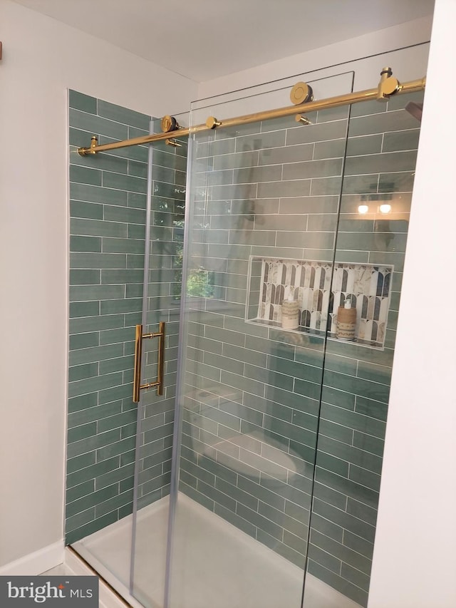 full bathroom with a tile shower