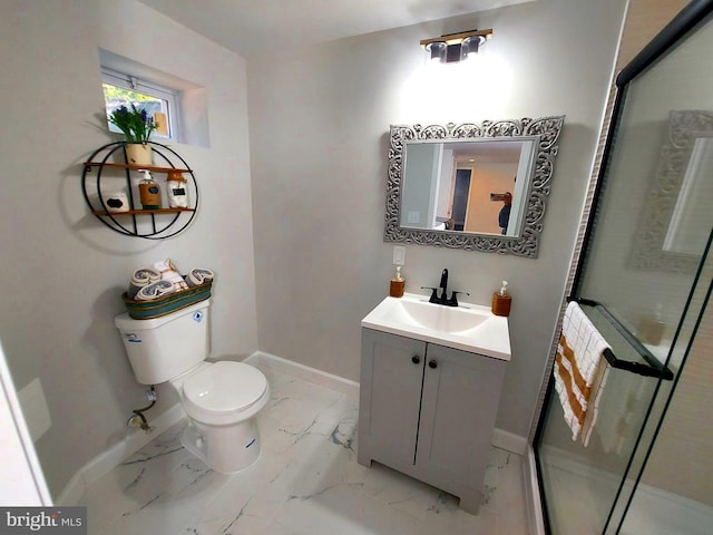 bathroom featuring marble finish floor, toilet, vanity, and baseboards