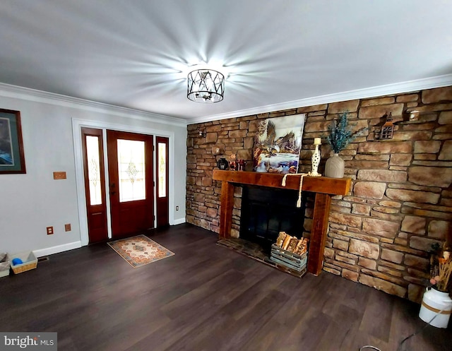 entryway with baseboards, a fireplace, ornamental molding, and dark wood finished floors