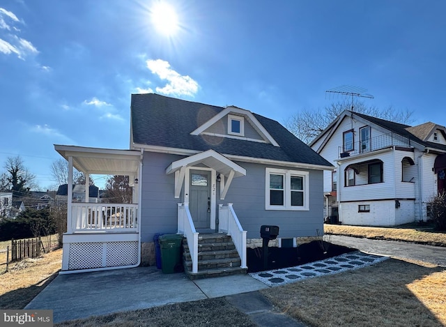 bungalow-style home with a shingled roof