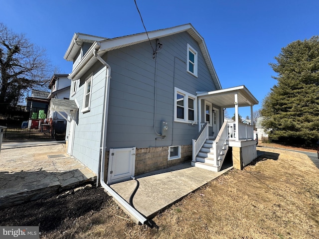 back of property with a porch