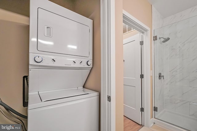 laundry room with stacked washer and dryer and laundry area