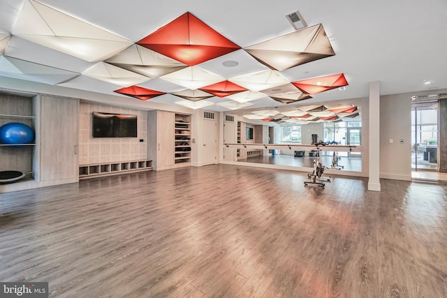 workout room featuring visible vents, plenty of natural light, and wood finished floors