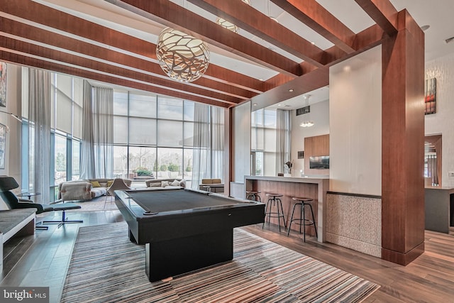 playroom featuring expansive windows, billiards, a high ceiling, and wood finished floors