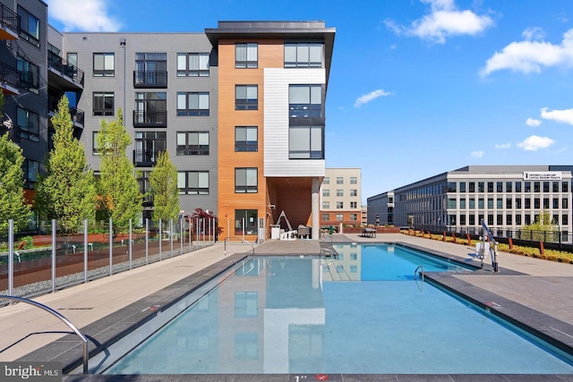 view of pool featuring a patio and fence