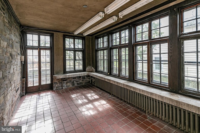 unfurnished sunroom with plenty of natural light