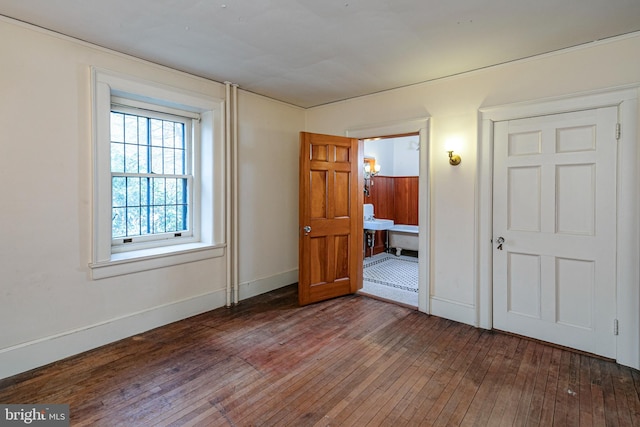 unfurnished bedroom featuring wood-type flooring and baseboards