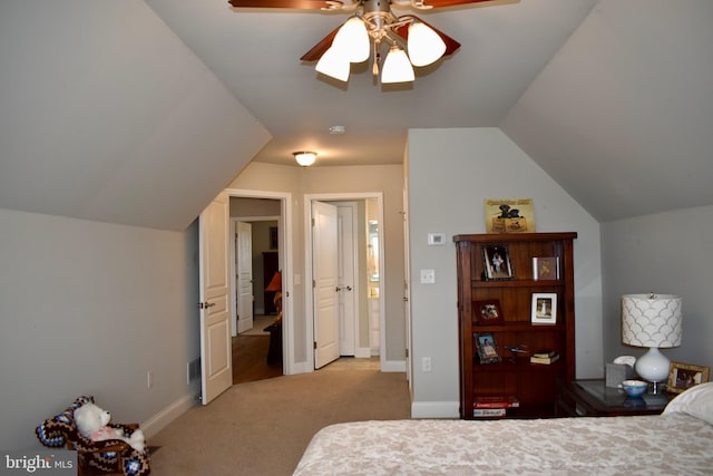 bedroom featuring lofted ceiling, baseboards, visible vents, and light colored carpet