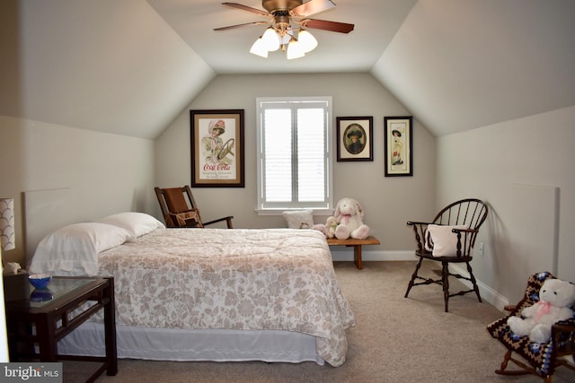 carpeted bedroom featuring a ceiling fan, vaulted ceiling, and baseboards