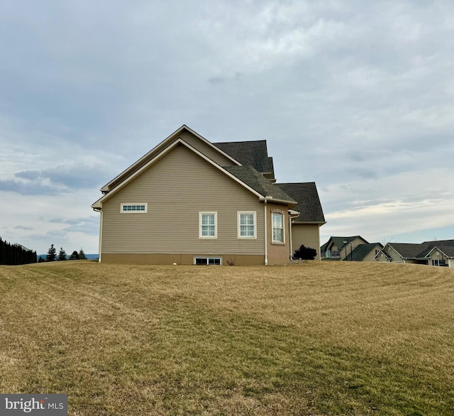 view of side of home with a lawn