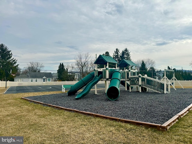 community playground featuring a lawn and fence