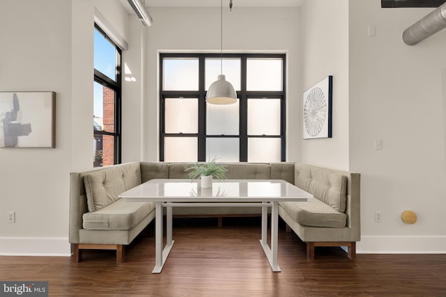 living area with wood finished floors and baseboards