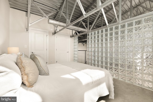 bedroom featuring concrete floors