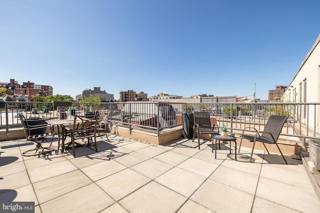 view of patio / terrace featuring a balcony and a city view